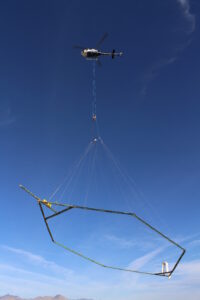 Helicopter in sky, Conducting airborne geophysical surveys
