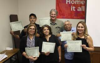 A group of people displaying certificates